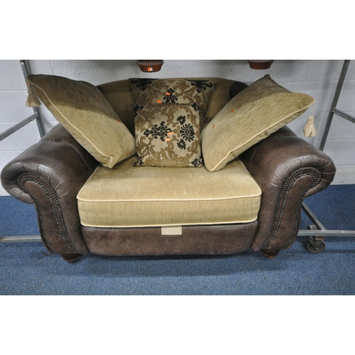 1245 - A BROWN LEATHER AND CREAM FABRIC UPHOLSTERED THREE PIECE LOUNGE SUITE, comprising a wide armchair, w... 