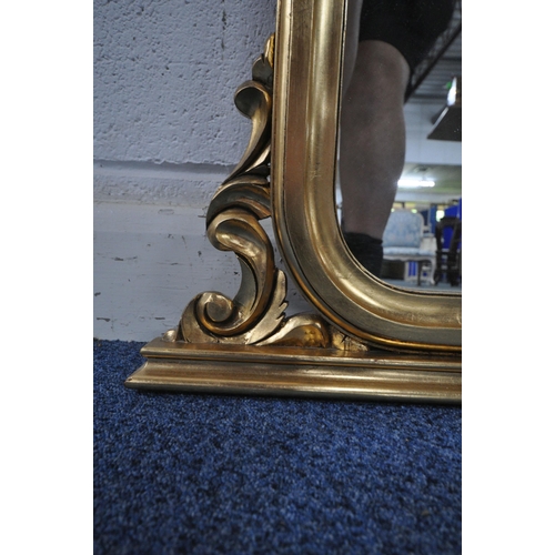 1254 - A LARGE GILT FRAMED ARCHED OVERMANTEL MIRROR, with scrolled details, width 140cm x height 111cm (con... 