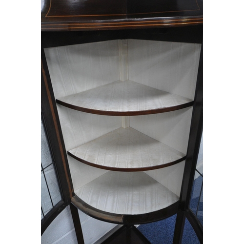 1258 - AN EDWARDIAN MAHOGANY BOW FRONT CORNER CUPBOARD, with a raised back, double lead lined stained glass... 