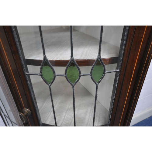 1258 - AN EDWARDIAN MAHOGANY BOW FRONT CORNER CUPBOARD, with a raised back, double lead lined stained glass... 