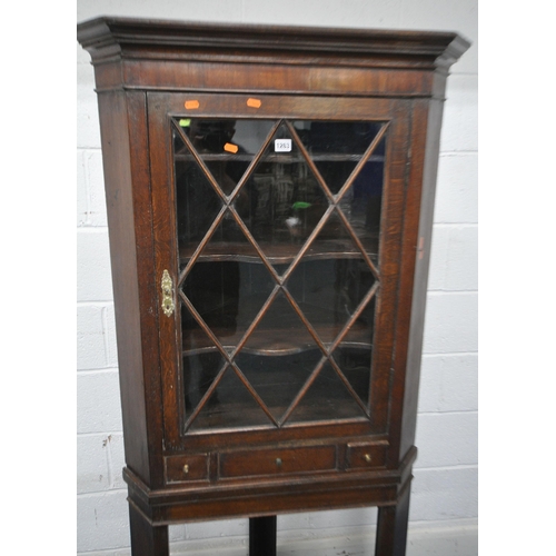 1263 - A GEORGIAN AND LATER OAK CORNER CUPBOARD, with a single astragal glazed door, above a single drawer ... 