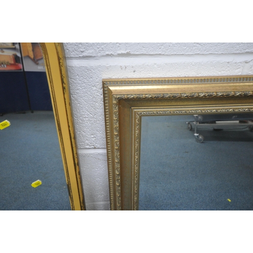 1267 - A RECTANGULAR GILT FRAMED BEVELLED EDGE WALL MIRROR, 106cm x 75cm, along with a slim gilt framed mir... 