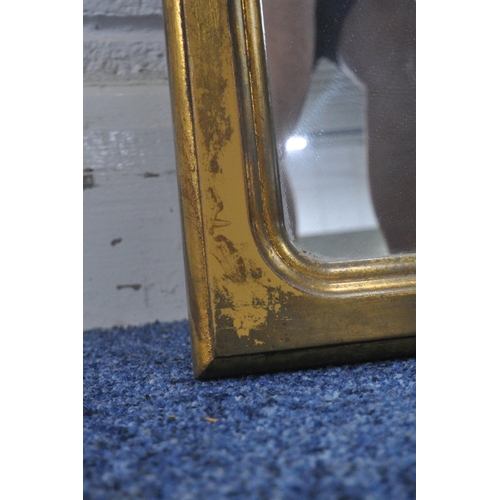 1267 - A RECTANGULAR GILT FRAMED BEVELLED EDGE WALL MIRROR, 106cm x 75cm, along with a slim gilt framed mir... 