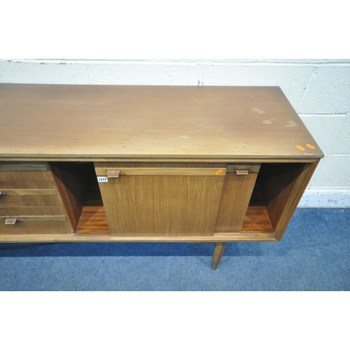 1277 - A MID CENTURY TEAK SIDEBOARD, fitted with a single cupboard door, three drawers and double sliding d... 