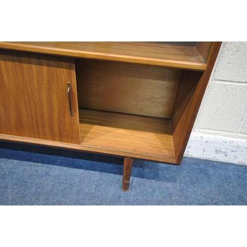 1281 - A MID CENTURY TEAK BOOKCASE, with double glazed sliding doors, above double sliding doors, width 138... 