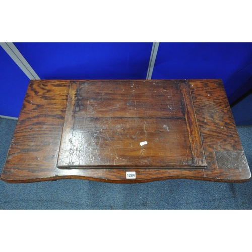 1284 - AN EARLY 20TH CENTURY STERLING TREADLE SEWING TABLE, with an oak case, four drawers, raised on a cas... 