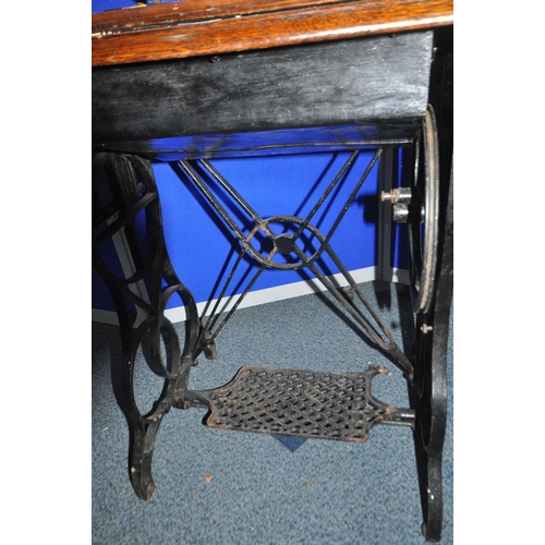 1284 - AN EARLY 20TH CENTURY STERLING TREADLE SEWING TABLE, with an oak case, four drawers, raised on a cas... 