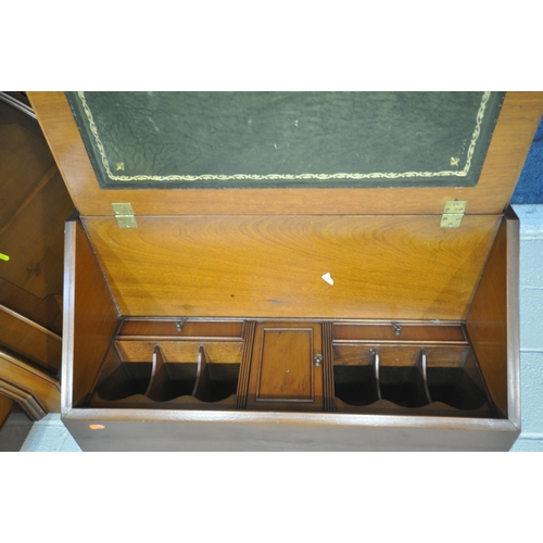 1292 - A REPRODUCTION MAHOGANY BUREAU, with a fall front door, enclosing a fitted interior, above four draw... 