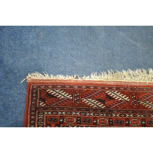 1300 - A 20TH CENTURY RED GROUND TEKKE RUG, with fourteen medallions, and a multi-strap border, 122cm x 93c... 