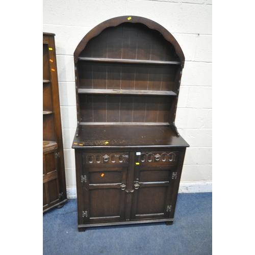 1317 - AN EARLY 20TH CENTURY OAK DRESSER, the arched two tier plate rack, atop a base with two drawers, abo... 