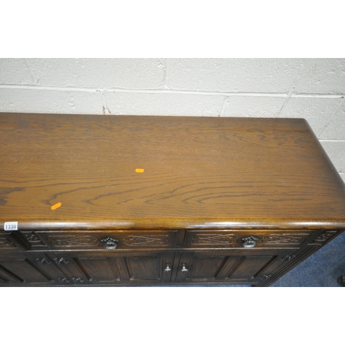 1330 - AN EARLY 20TH CENTURY OAK SIDEBOARD, fitted with four drawers, above four cupboard doors, length 191... 