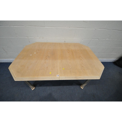 1336 - A BLONDE OAK EXTENDING DINING TABLE, with a single fold out leaf, open length 202cm x closed length ... 