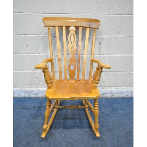 1337 - A LATE 20TH CENTURY ELM ROCKING CHAIR, the central splat with heart and geometric shapes, shaped arm... 