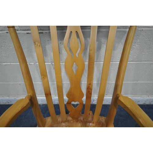 1337 - A LATE 20TH CENTURY ELM ROCKING CHAIR, the central splat with heart and geometric shapes, shaped arm... 