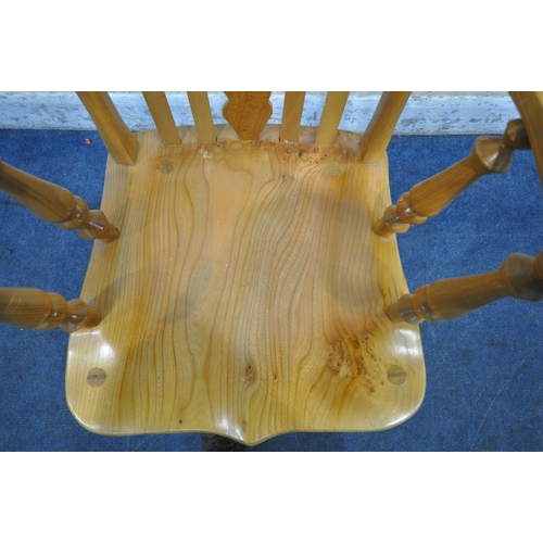 1337 - A LATE 20TH CENTURY ELM ROCKING CHAIR, the central splat with heart and geometric shapes, shaped arm... 