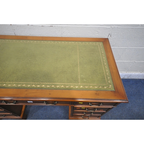 1351 - A 20TH CENTURY YEW WOOD TWIN PEDESTAL DESK, with a green leather writing surface, fitted with eight ... 