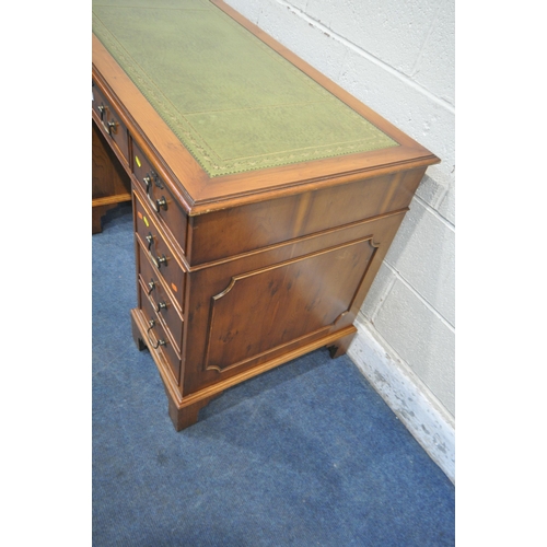 1351 - A 20TH CENTURY YEW WOOD TWIN PEDESTAL DESK, with a green leather writing surface, fitted with eight ... 