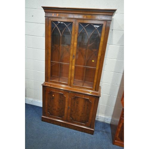 1353 - BERESFORD AND HICKS OF ENGLAND, A LATE 20TH CENTURY YEW WOOD CABINET, with three glazed doors, a fal... 