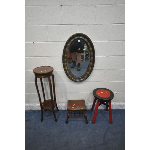 1357 - AN OVAL BEVELLED EDGE WALL MIRROR, 80cm x 52cm, a red and black painted stool, a small elm stool and... 