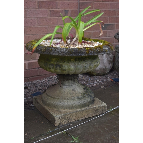 1005 - A PAIR OF LOW WEATHERED COMPOSITE CAMPAGNA GARDEN URNS, on a square base, diameter 57cm x height 46c... 