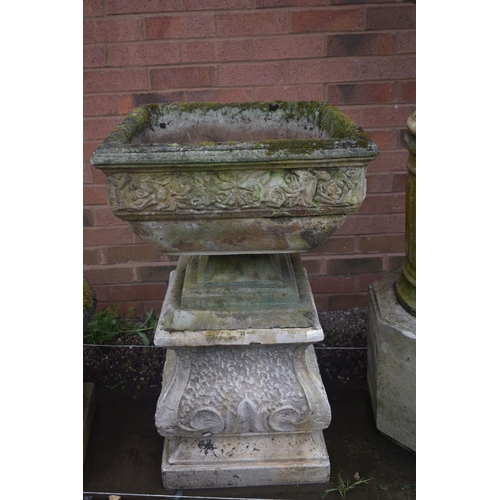 1006 - A SQUARE WEATHERED COMPOSITE GARDEN PLANTER, with a floral border, on a later separate plinth, 53cm ... 