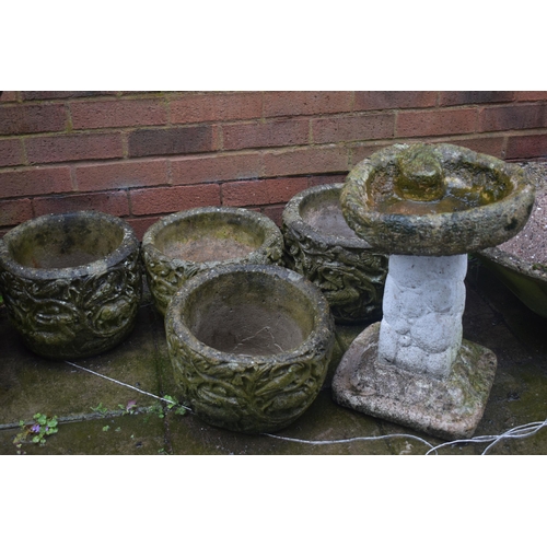 1010 - A SET OF FOUR WEATHERED COMPOSITE PLANTERS, diameter 32cm x height 24cm, along with a composite bird... 