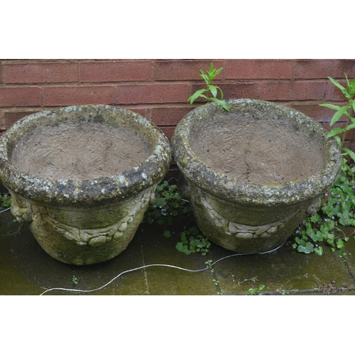 1011 - A PAIR OF WEATHERED COMPOSITE CYLINDRICAL PLANTERS, with swag detail, diameter 49cm x height 36cm, a... 