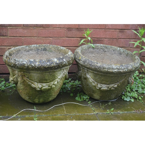 1011 - A PAIR OF WEATHERED COMPOSITE CYLINDRICAL PLANTERS, with swag detail, diameter 49cm x height 36cm, a... 