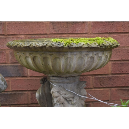 1016 - A WEATHERED COMPOSITE BIRD BATH, on a separate base with three clad ladies in flowing robes, diamete... 