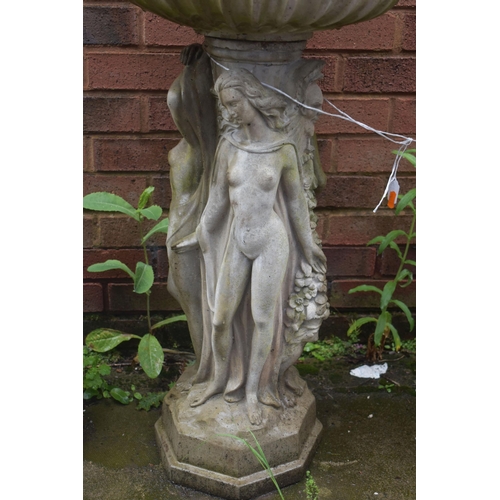 1016 - A WEATHERED COMPOSITE BIRD BATH, on a separate base with three clad ladies in flowing robes, diamete... 