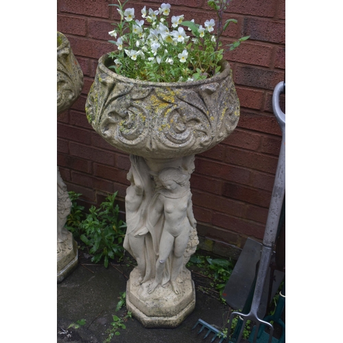 1026 - A PAIR OF CREAM WEATHERED COMPOSITE GARDEN PLANTER, on separate bases with three clad ladies in flow... 