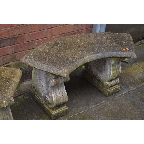 1029 - A PAIR OF WEATHERED COMPOSITE CURVED BENCHES, on scrolled bases, length 96cm x height 43cm (2)