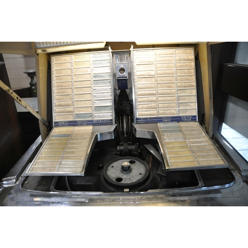 1107 - A 1960s AMI INCORPORATED MODEL K JUKEBOX JJK-200 with a vast array of 45s in mechanism, no keys but ... 