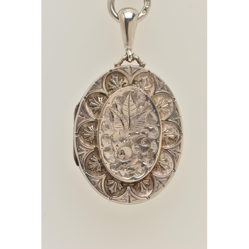 28 - A VICTORIAN SILVER LOCKET AND BOOK CHAIN, an oval locket with embossed floral detail, approximate le... 