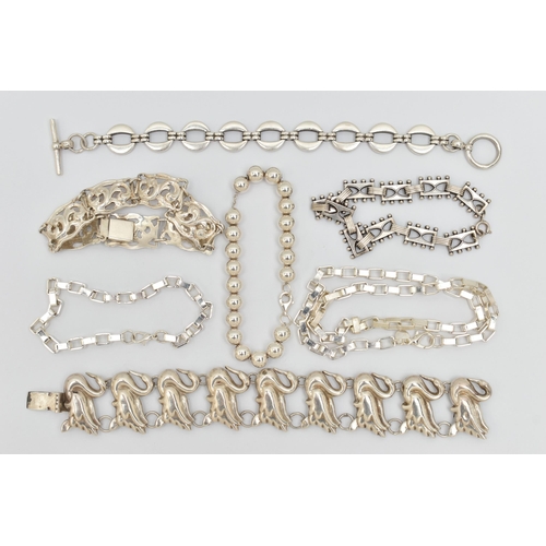 37 - SIX ITEMS OF WHITE METAL JEWELLERY, to include a swan bracelet, a scrolling acanthus panel bracelet,... 