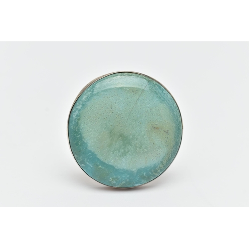 38 - A CERAMIC 'RUSKIN' BROOCH, a circular form brooch with white metal mount, fitted with a pin and C cl... 