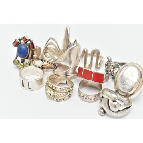 39 - AN ASSORTMENT OF THIRTEEN WHITE METAL RINGS, to include a selection of abstract designs and gem set ... 