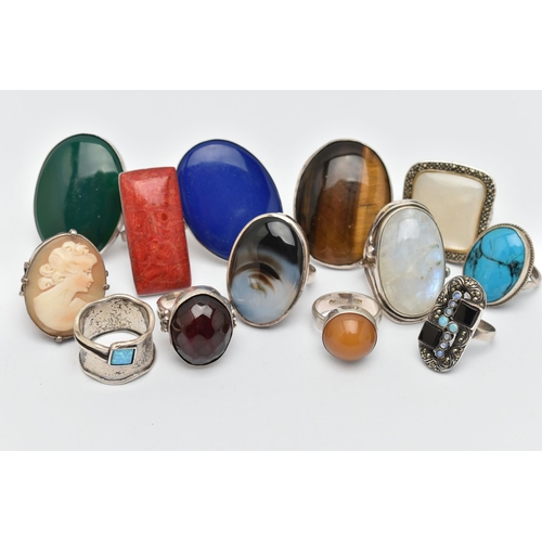 41 - AN ASSORTMENT OF THIRTEEN WHITE METAL RINGS, large statement rings, each set with a hard stone or sh... 