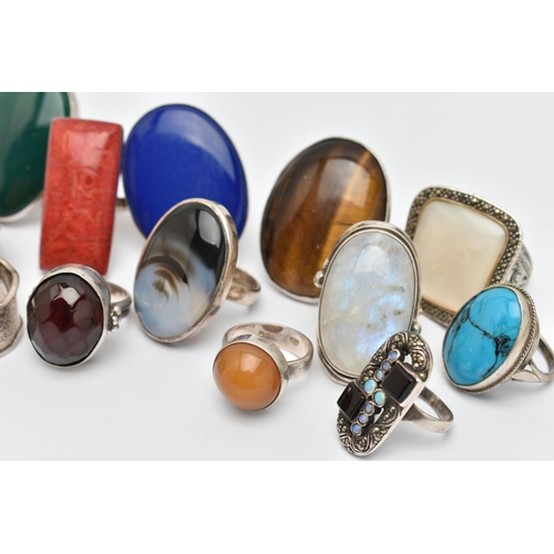 41 - AN ASSORTMENT OF THIRTEEN WHITE METAL RINGS, large statement rings, each set with a hard stone or sh... 