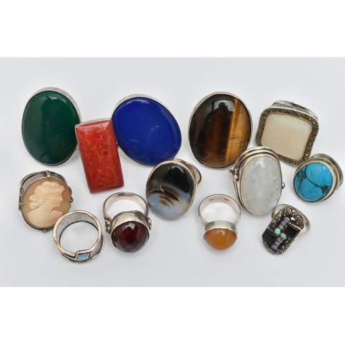 41 - AN ASSORTMENT OF THIRTEEN WHITE METAL RINGS, large statement rings, each set with a hard stone or sh... 