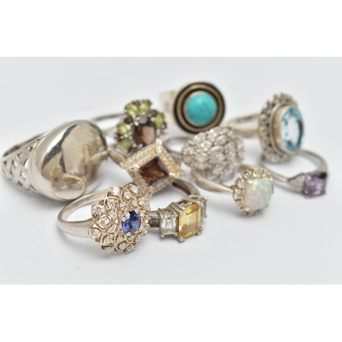 44 - TEN SILVER AND WHITE METAL RINGS, to include an oval topaz ring, a large oval panel ring, a circular... 