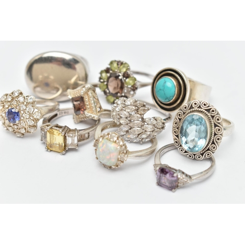 44 - TEN SILVER AND WHITE METAL RINGS, to include an oval topaz ring, a large oval panel ring, a circular... 