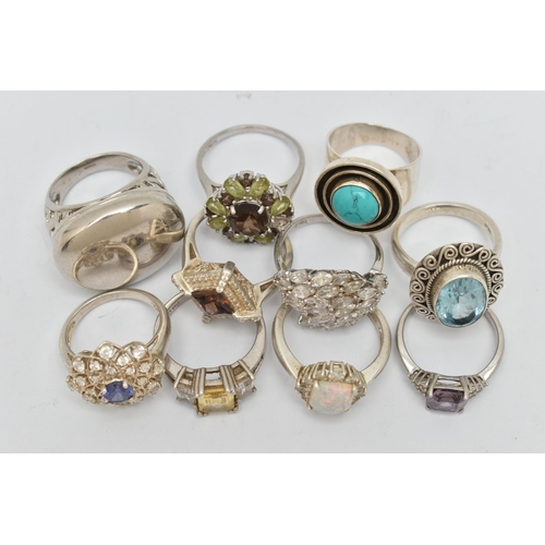 44 - TEN SILVER AND WHITE METAL RINGS, to include an oval topaz ring, a large oval panel ring, a circular... 