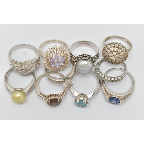 48 - TEN WHITE METAL RINGS, to include various designs set with cubic zironia, including cluster rings, c... 