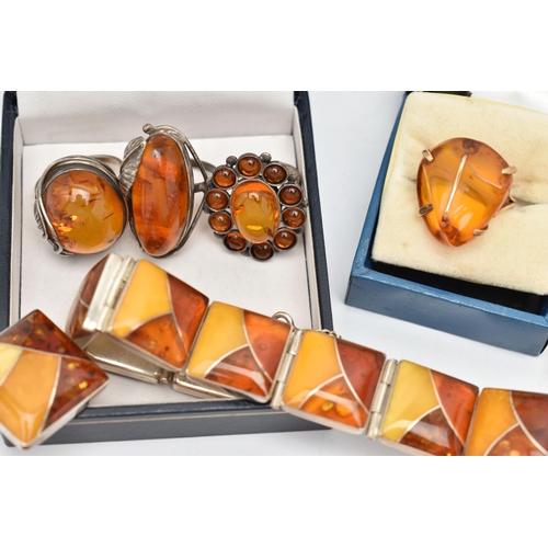 69 - AN ASSORTMENT OF COPAL AMBER JEWELLERY, to include an amber ring set win a yellow metal mount, stamp... 