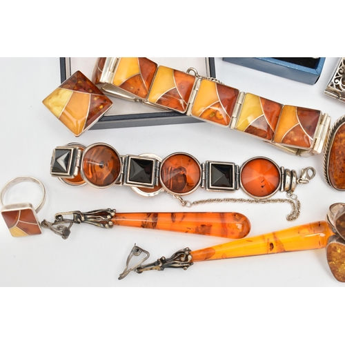 69 - AN ASSORTMENT OF COPAL AMBER JEWELLERY, to include an amber ring set win a yellow metal mount, stamp... 