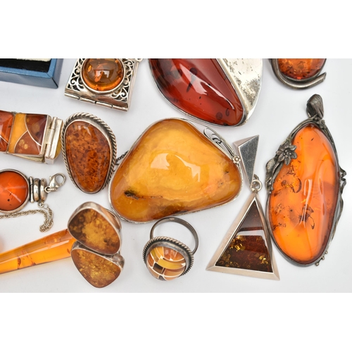 69 - AN ASSORTMENT OF COPAL AMBER JEWELLERY, to include an amber ring set win a yellow metal mount, stamp... 