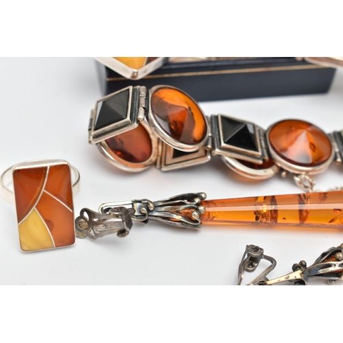 69 - AN ASSORTMENT OF COPAL AMBER JEWELLERY, to include an amber ring set win a yellow metal mount, stamp... 