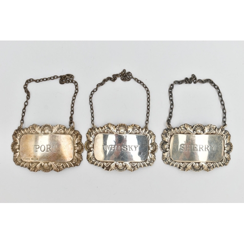 79 - THREE SILVER DECANTER LABELS, all with embossed decorative borders of shell and acanthus leaf detail... 