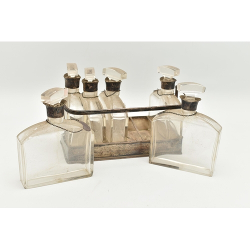 100 - A GEORGE V SILVER AND GLASS DECANTER SET, six glass decanters fitted with silver collars and decante... 